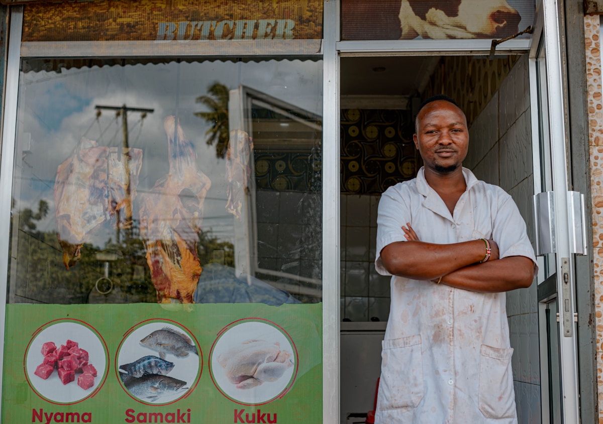 Kenyan small business owner outside his shop